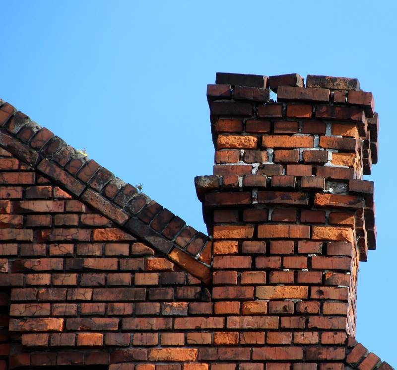 Damaged chimney on an Woodridge home showing cracks and missing mortar